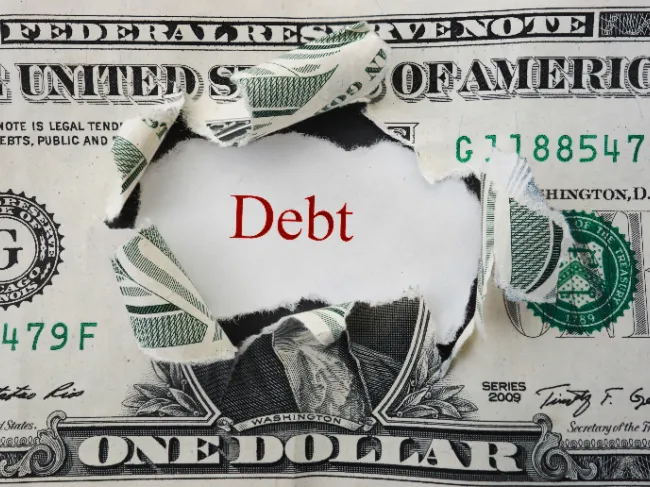 dollar bill with debt